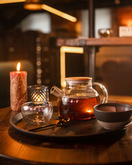 Fototapeta na wymiar Tea brewing process, tea ceremony, freshly brewed red tea cup, warm soft light, dark background.
