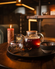 Tea brewing process, tea ceremony, freshly brewed black tea cup, warm soft light, dark background.
