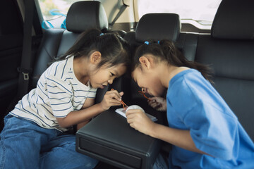 Two asian child girls eating dessert together while traveling in the car. Childhood and family lifestyles in car concept.