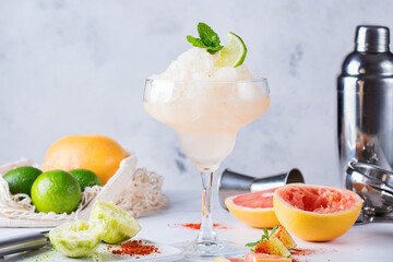 Frozen Mezcal or mescal Margarita cocktail with grapefruit and lime