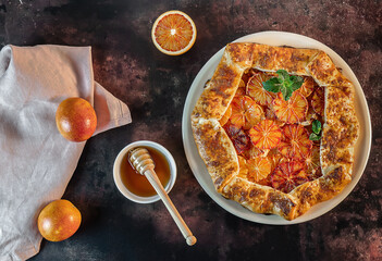 Delicious galette with red blood oranges with mint and honey. Homemade citrus tart. Healthy...