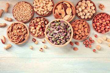 Nuts with copy space on a wooden background, top shot