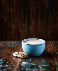 Cappuccino and Cantuccini (Italian cookie) on dark wooden background. Copy space.	