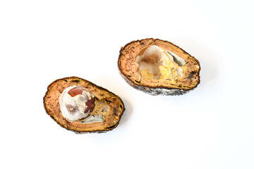 Rotten avocado fruit on white background isolated. Rotten avocado cutting half with black skin and...