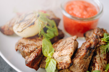 meat marinated for barbecue grilled and served on a white plate