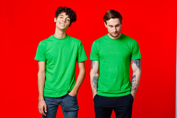 two men in green t-shirts three squads emotions fun