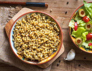 Boiled Ptitim or Birdy, Israeli pasta couscous with salad