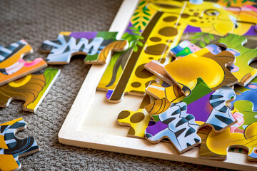 Color puzzle on a wooden background. Children's puzzles