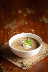 Close-up of Methi, matar malai with white curry. A popular, delicious Indian recipe in the white ceramic bowl.. Over wooden background