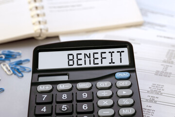 Calculator with the word Benefit on the display