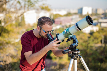 Amateur astronomer looking at the sky with a telescope.