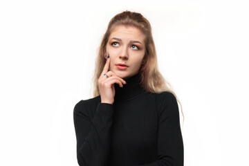 Close up girl with a concentrated look, wondering with a doubtful expression, looking up and to the...