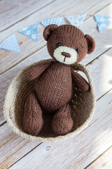 A brown bear in a wicker basket.