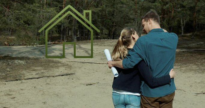 embraced couple standing on purchased building plot of land in forest and planning their dream house