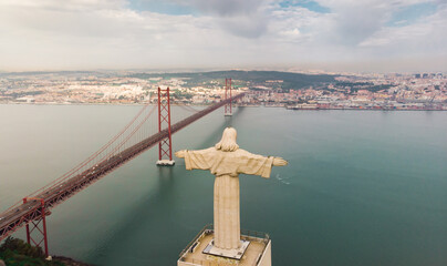 Aerial panorama view over the 25 de Abril Bridge. The bridge is connecting the city of Lisbon to the municipality of Almada on the left bank of the Tejo river, Lisbon
