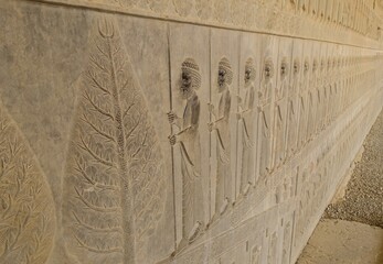 Obraz na płótnie Canvas beautiful relief of some soldiers with spears in the ancient ruins of Persepolis (Iran)