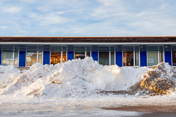 Kiruna, Sweden A pile of plowed snow in front of a building.