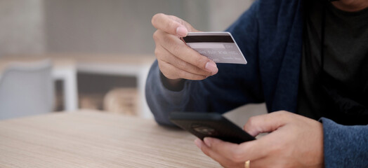 Online payment,Man's hands holding a credit card and using smart phone for online shopping