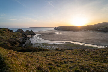 Three Cliff's Bay and Penard pill river at sunset, the Gower peninsula, Swansea, South Wales, UK