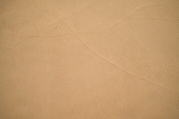 Natural brown sand background, surface and texture.