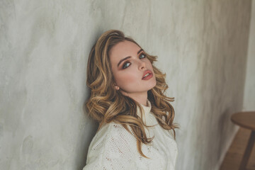 Fototapeta premium Attractive woman posing near gray stucco wall