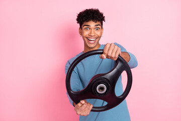 Photo of young excited black man happy positive smile steering-wheel drive auto isolated over pink color background