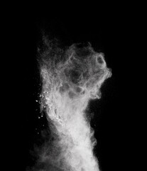 White powder explosion isolated on black background