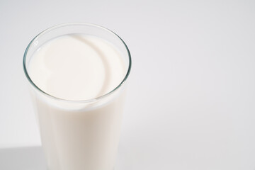 a glass of milk on a white background. selling farm products. Place for the inscription.
