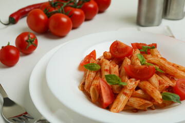 Concept of tasty food with pasta with tomato sauce on white background