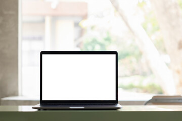 White blank screen tablet on modern working desk with garden background.