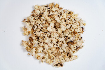 spoiled burnt popcorn grains on white background