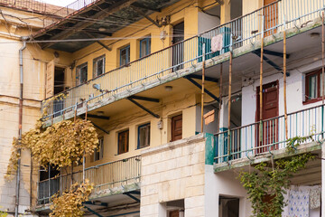 Fototapeta na wymiar Shared balconies in Sevastopol courtyards. Preserved courtyards with climbing vines. Pleasant autumn in Sevastopol.