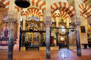 Fototapeta na wymiar Interior view of La Mezquita Cathedral in Cordoba Spain. The cathedral was built inside of the former Great Mosque. Popular tourist destination in Spain.