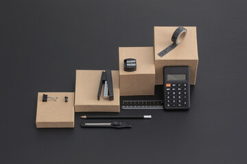 Office and school stationery on black leather background. Back to school. Items on square stages