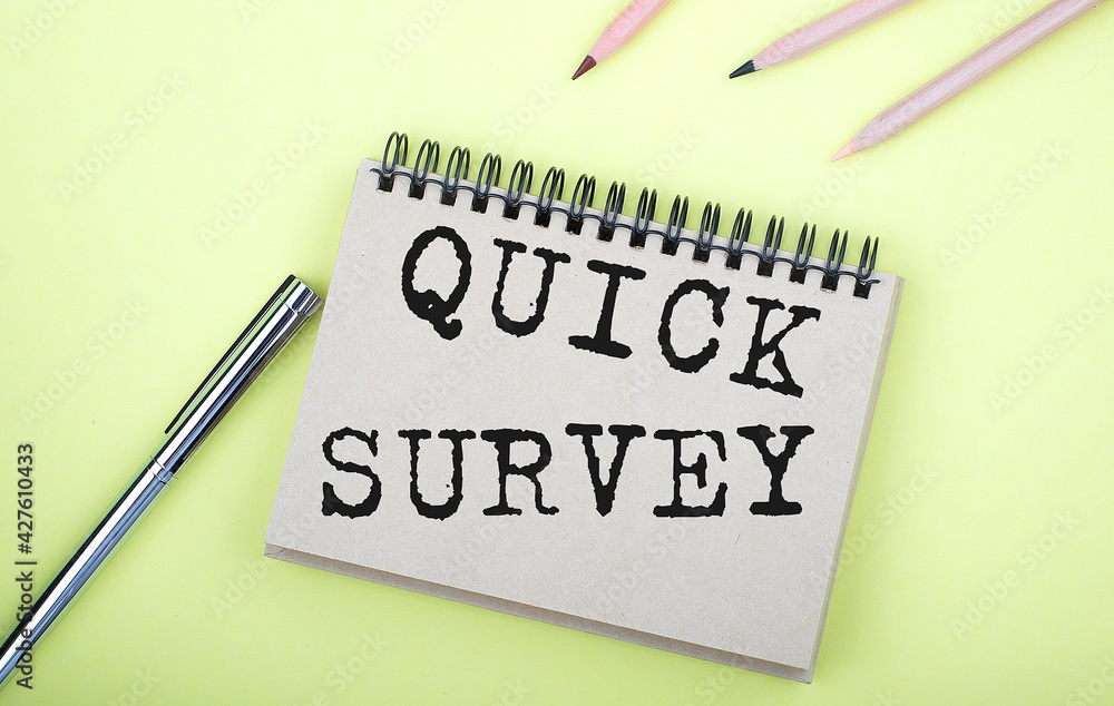 Poster quick survey text written on a notebook with pencils