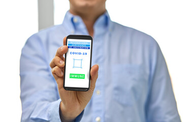 technology and health care concept - close up of man showing smartphone with virtual immunity passport or international certificate of vaccination on screen at office