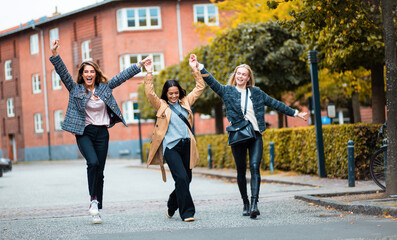 Three women having fun on the street.