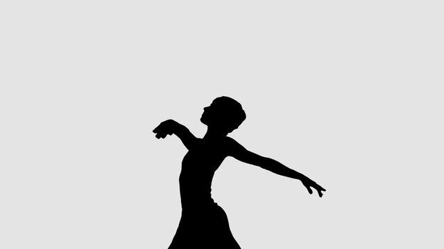 Silhouette of elegant ballerina dancing classical ballet.