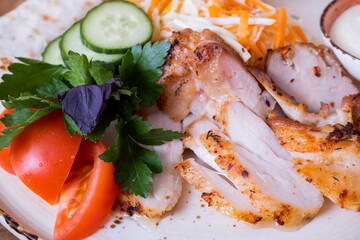 Vegetable salad with chicken. Sliced vegetables with meat on a plate. Shawarma on a plate.