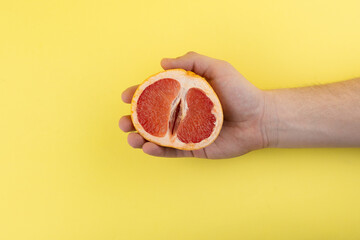 hand holds half of grapefruit