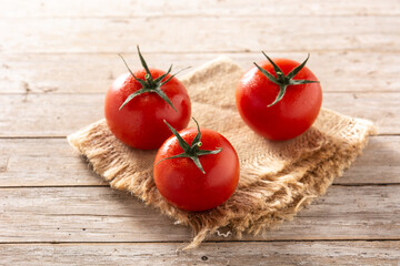 Organic fresh tomatoes on rustic wooden table