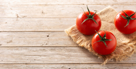 Organic fresh tomatoes on rustic wooden table.Panorama view