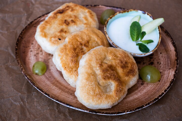 Tasty breakfast. Three pancakes with sour cream on a plate.