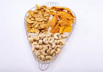 Roasted and salted fava beans, cashew nuts and dried mango slices for a healthy vegan and vegetarian diet snack. High in protein, vitamins, dietary fibre and nutrients