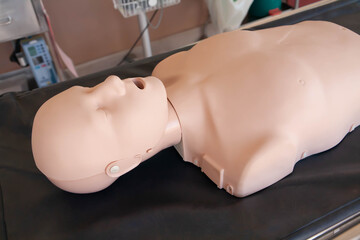 Medical manikin on stretcher. Dummy, equipment for demonstrate and practice medical procedure. Side view. Selective focus