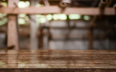 Empty wooden table top with lights bokeh on blur restaurant background.