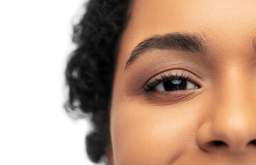 beauty and people concept - portrait of happy smiling young african american woman with bare shoulders over white background