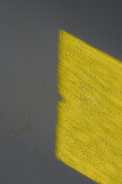 Textured wall shadows illuminating yellow and ultimate gray