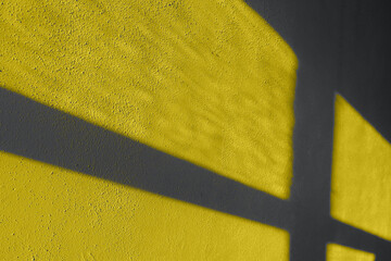 Textured wall shadows illuminating yellow and ultimate gray