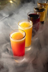 alcoholic cocktails amid the smoke on the bar counter